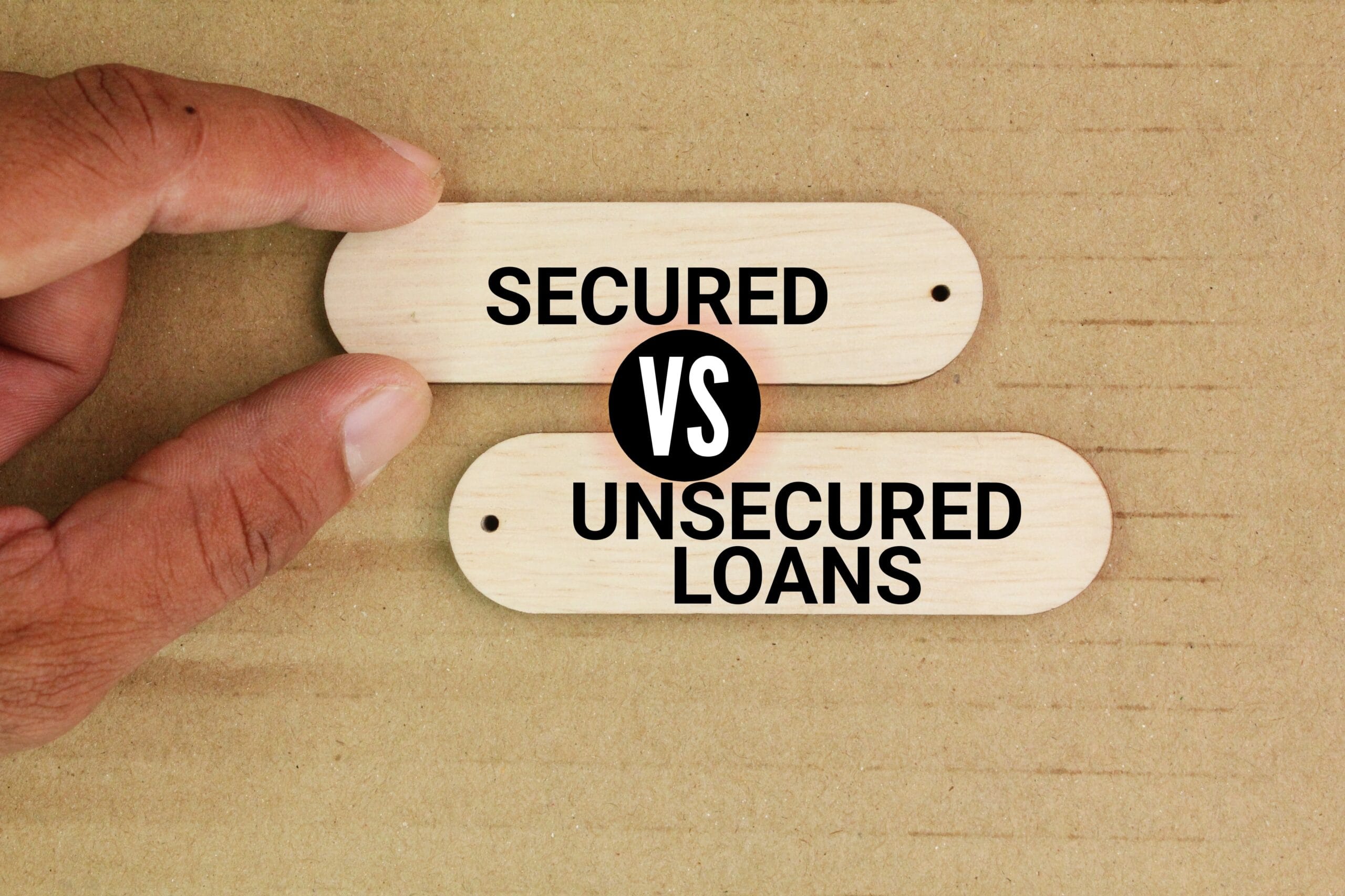 wood with the words Secured vs Unsecured Loan. Business loan concept